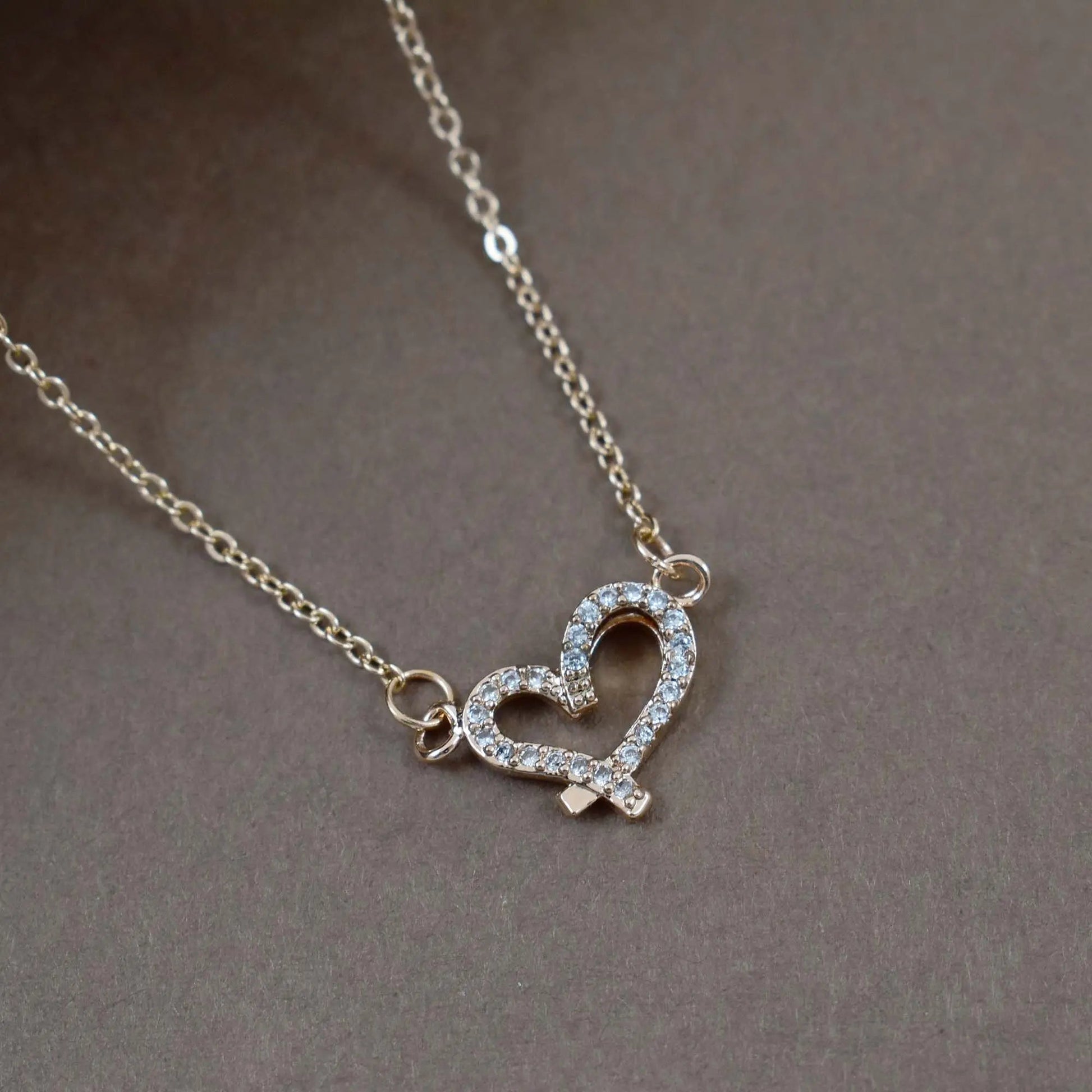 Criss cross studded heart gold necklace
