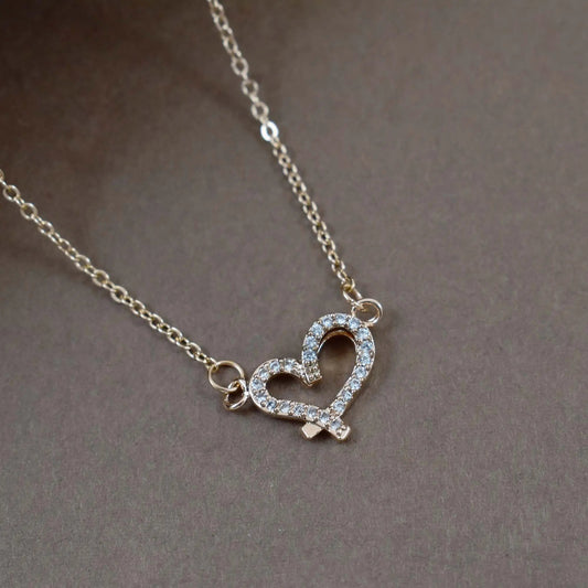 Criss cross studded heart gold necklace