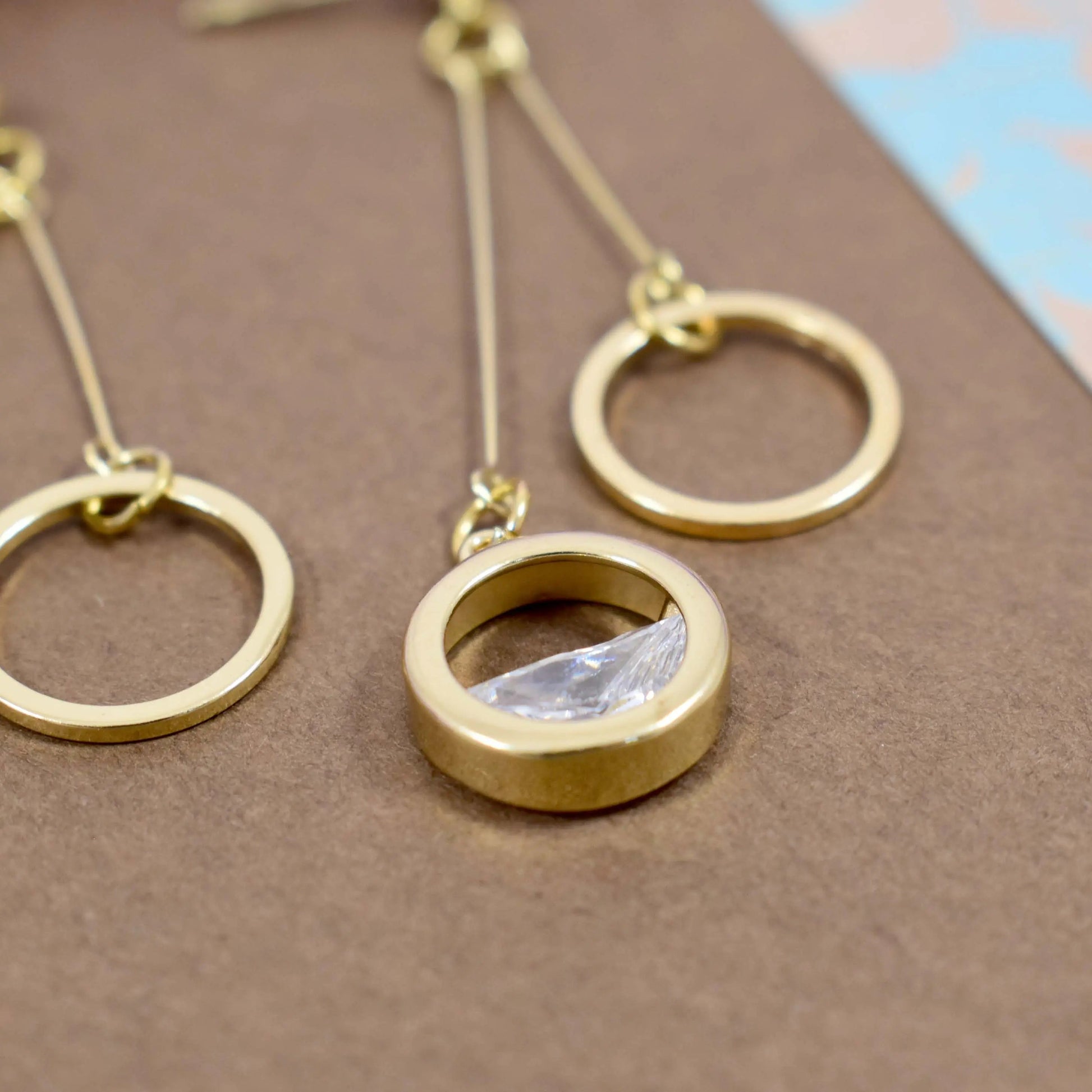 Crystal detail gold ring drop earrings